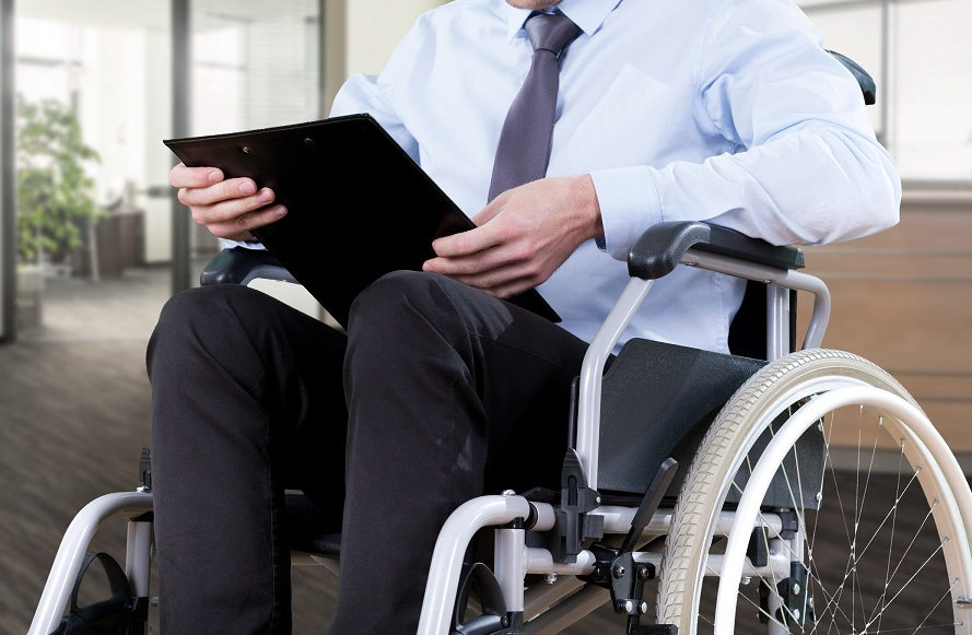 a man in a wheelchair with documents in his hands